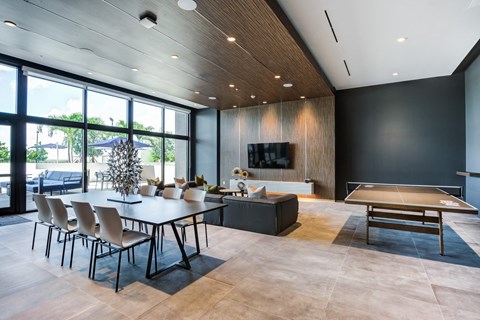 a dining room and living room with a ping pong table